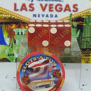 May include: Red and white dice with the words "Slots-A-Fun" on each side. A red and white casino chip with the words "Slots-A-Fun" and "Las Vegas, Nevada" on it.