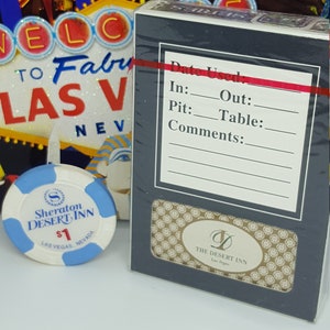 May include: A blue and white casino chip with the text "Sheraton Desert Inn $1 Las Vegas, Nevada". A black and white card deck with the text "The Desert Inn Las Vegas" and a form for "Date Used" with fields for "In", "Out", "Pit", "Table", and "Comments".