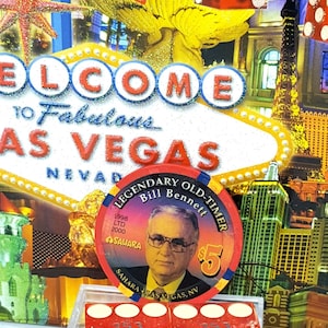 May include: A Las Vegas-themed display featuring the "Welcome to Fabulous Las Vegas" sign, dice, and a casino chip with Bill Bennett's portrait. The dice are red with white dots and the chip reads "Legendary Old-Timer".