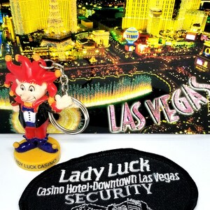 Vintage MCM Lady Luck Las Vegas mad money joker keychain and an old Lady Luck Security officer patch Lady Luck souvenir keyring