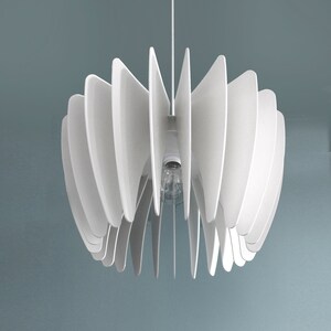 May include: White ceiling light fixture with a modern design. The light fixture is made of multiple thin, white, curved panels that create a flower-like shape.