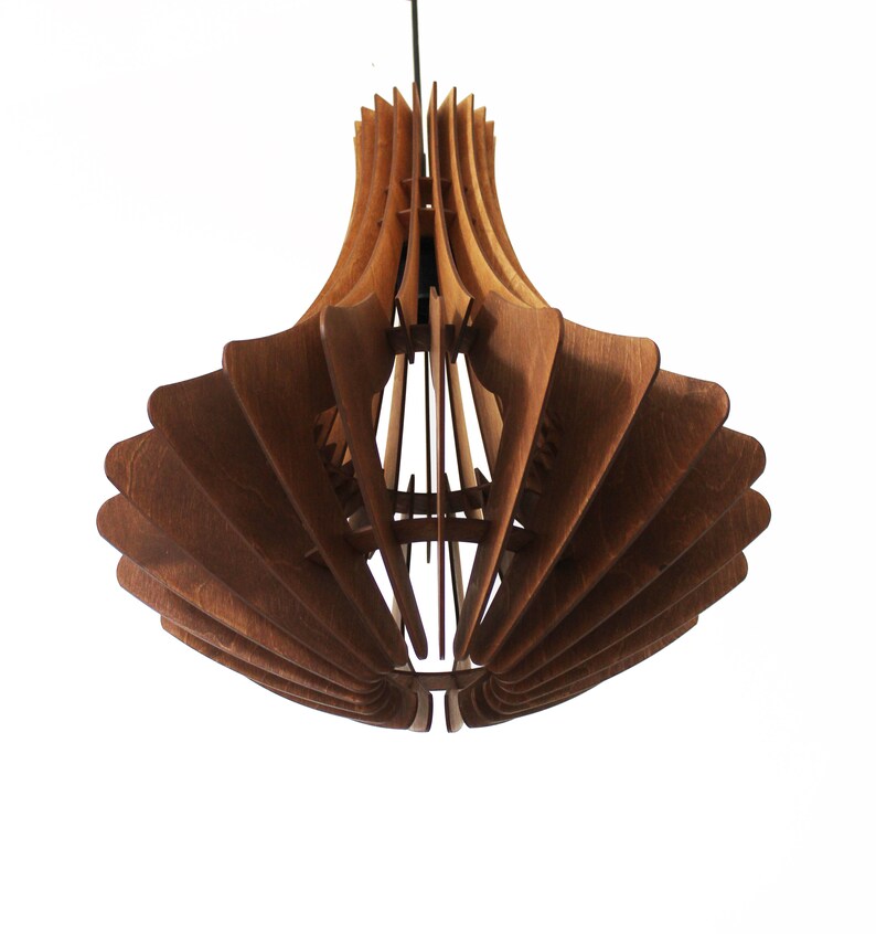 May include: A wooden pendant light fixture with a unique, layered design. The fixture is made of multiple wooden slats arranged in a fan-like pattern, creating a warm, inviting glow. The light hangs from a black cord, perfect for a modern home.