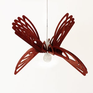 May include: A red wooden pendant light shaped like a butterfly with a single light bulb in the center.