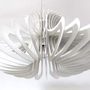 May include: A white, modern, geometric ceiling light fixture with a unique, organic design. The light fixture is made of multiple layers of thin, curved wood panels that create a delicate and airy look.