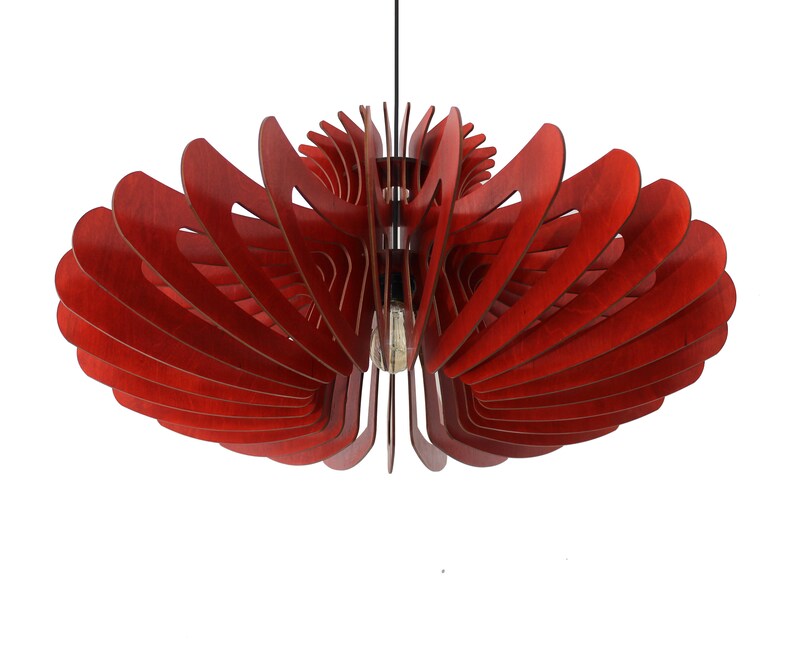 May include: A red wooden pendant light fixture with a unique, geometric design. The light fixture is made of multiple layers of wood that are arranged in a spiral pattern.