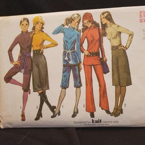 May include: A Simplicity sewing pattern envelope, number 9556, for size 14 with a 36-inch bust. The front displays five illustrations of outfits including turtlenecks, pants, and skirts in various colors. The text reads Designed for knit fabrics only.