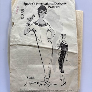 May include: A vintage Spadea's International Designer Pattern S-388 by J.P. Gallegno for a dress. The paper envelope features black line illustrations of a dress with a contrasting neckline band and bow, with text describing a semifitted front and loose back.