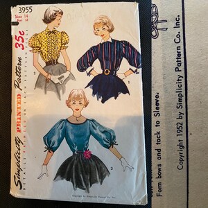 May include: A vintage Simplicity sewing pattern envelope number 3955 for size 14, bust 32. The front displays three illustrations of blouses with puff sleeves and skirts, including text details like 35c and Copyright 1952 by Simplicity Pattern Co. Inc.