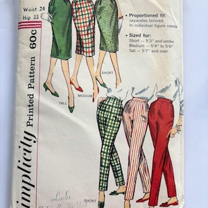May include: A vintage Simplicity 3257 sewing pattern envelope featuring illustrations of skirts and trousers in various patterns and solid colors. The text includes Waist 24, Hip 33, 60c, and sizing information for short, medium, and tall heights.