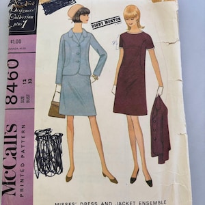 May include: A vintage McCall's printed pattern envelope for a misses' dress and jacket ensemble, number 8460, size 12, bust 32. The illustration shows two outfits: a light blue jacket and skirt set, and a dark maroon short-sleeved dress.