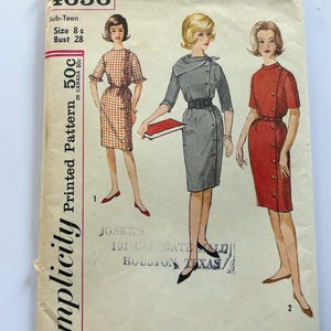 May include: A vintage Simplicity sewing pattern envelope 4656 for a sub-teen size 8 with a 28-inch bust. The cover features illustrations of three dresses: a plaid dress with ruffles, a grey dress with a wide collar and belt, and a red dress with buttons.