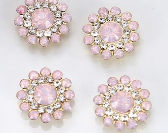 Pode incluir: Quatro enfeites de strass rosa e dourado com um grande strass rosa no centro de cada um.