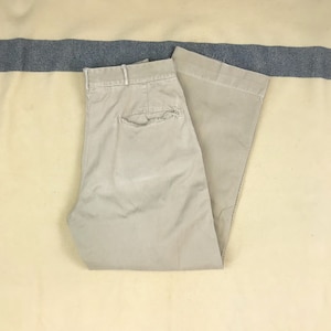 May include: A pair of light beige casual pants with a single back pocket.
