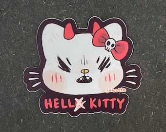 Könnte beinhalten: Ein weißer Hello Kitty-Aufkleber mit roten Teufelshörnern und einer roten Schleife mit einem Totenkopf. Der Text "HELLxKITTY" befindet sich unter dem Bild. Der Aufkleber befindet sich auf einem dunkelgrauen Hintergrund.