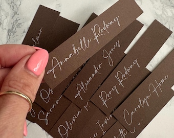 Brown place cards with white ink menu name tags