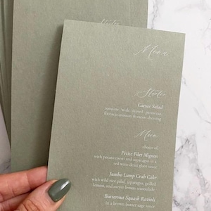 Sage green wedding menu without place card on the day table plan