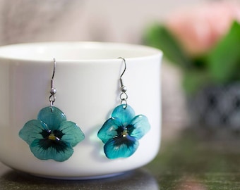 Teal pansy flower earrings. Comes in a gift box.