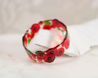 Poppy bangle. Transparent and unique, entirely made and shaped by hand. Made in Britain.