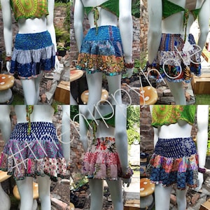 May include: Six different patchwork skirts with elastic waistbands. Each skirt is made from a variety of colorful fabrics, including floral prints, paisley patterns, and geometric designs. The skirts are all knee-length and have a tiered, ruffled design.
