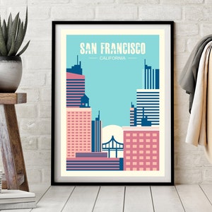 May include: A framed print of a stylized cityscape of San Francisco, California. The print features a blue sky, pink and blue buildings, and a bridge in the background. The text "SAN FRANCISCO - CALIFORNIA" is at the top of the print.