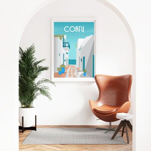May include: A white framed poster with a blue background and a white building with a blue door. The poster says "CORFU" in blue letters. The poster is hanging on a white wall in a room with a brown leather egg chair and a small wooden side table.