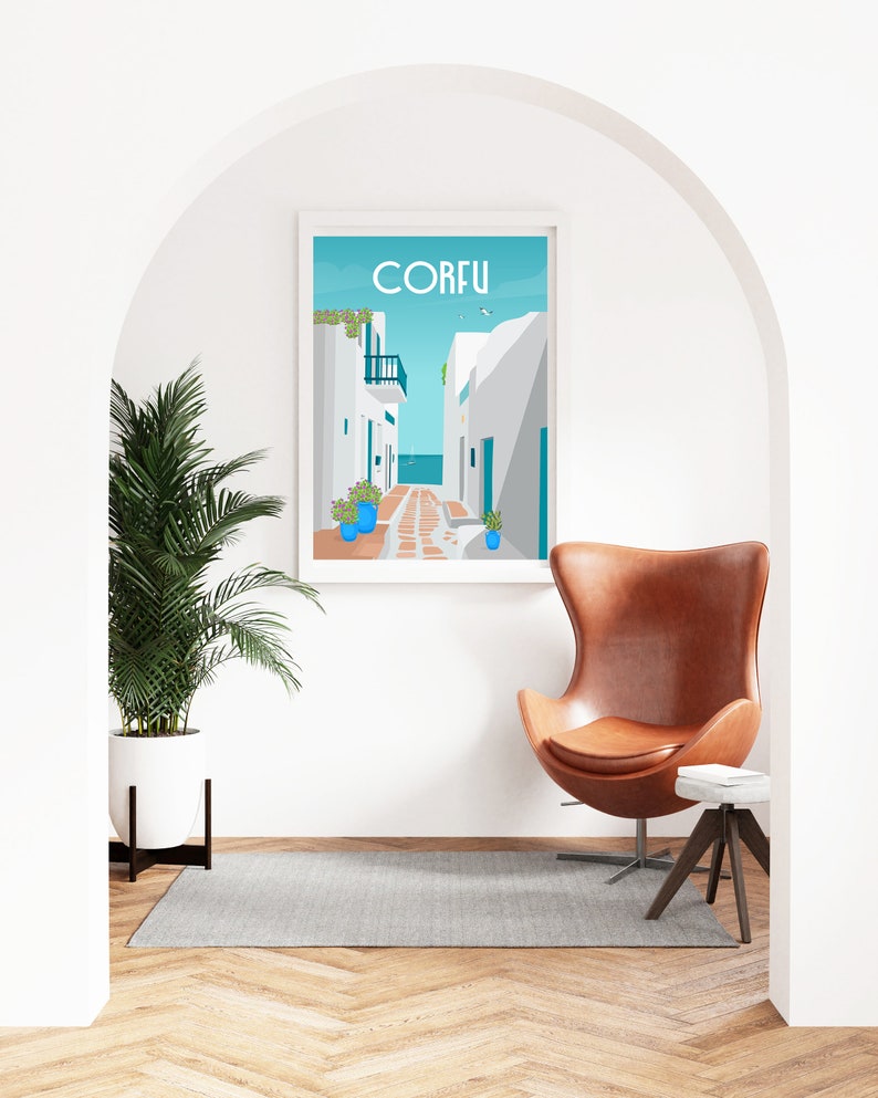 May include: A white framed poster with a blue background and a white building with a blue door. The poster says "CORFU" in blue letters. The poster is hanging on a white wall in a room with a brown leather egg chair and a small wooden side table.