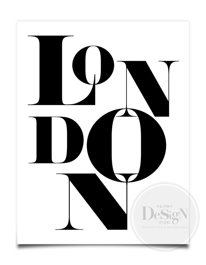 May include: Black and white graphic design print with the word "LONDON" in bold, stylized lettering. The print includes the text "The Print Design Studio" in a smaller font.