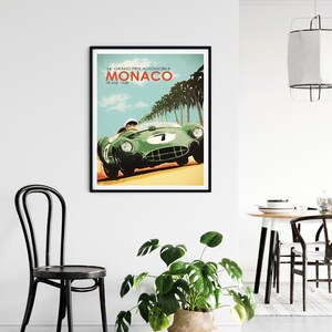 May include: A vintage poster featuring a green race car driving through a palm tree lined road. The poster reads "16 GRAND PRIX AUTOMOBILE MONACO 18 mai 1958".