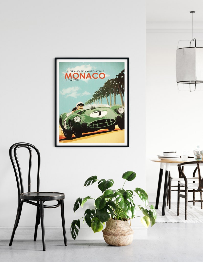 May include: A vintage poster featuring a green race car driving through a palm tree lined road. The poster reads "16 GRAND PRIX AUTOMOBILE MONACO 18 mai 1958".