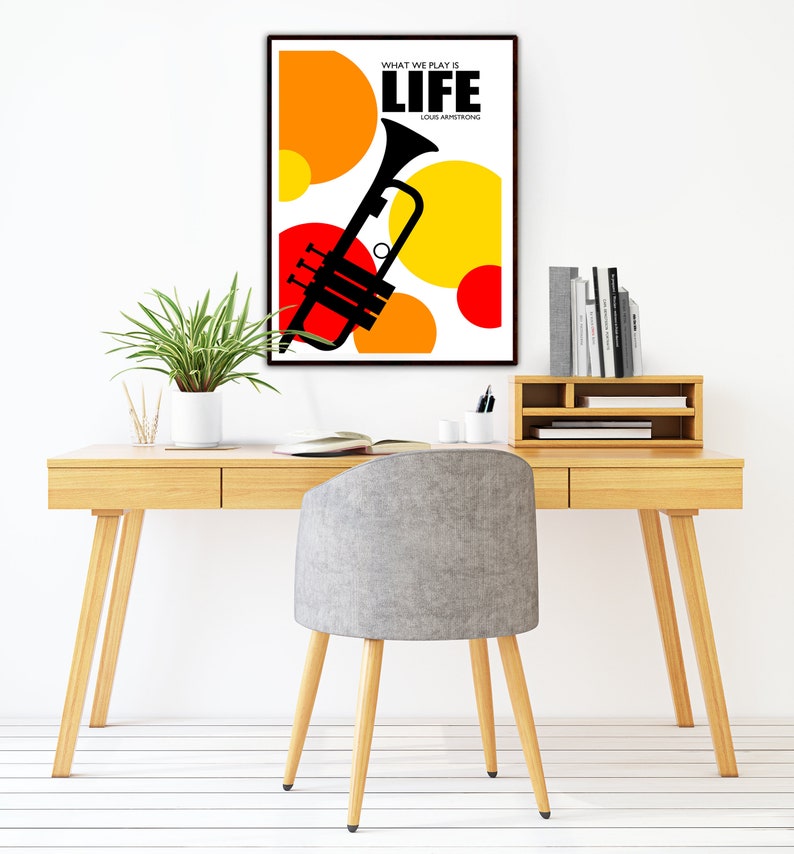 May include: A black and white poster with a trumpet and colorful circles. The text on the poster reads "What we play is life" and "Louis Armstrong".