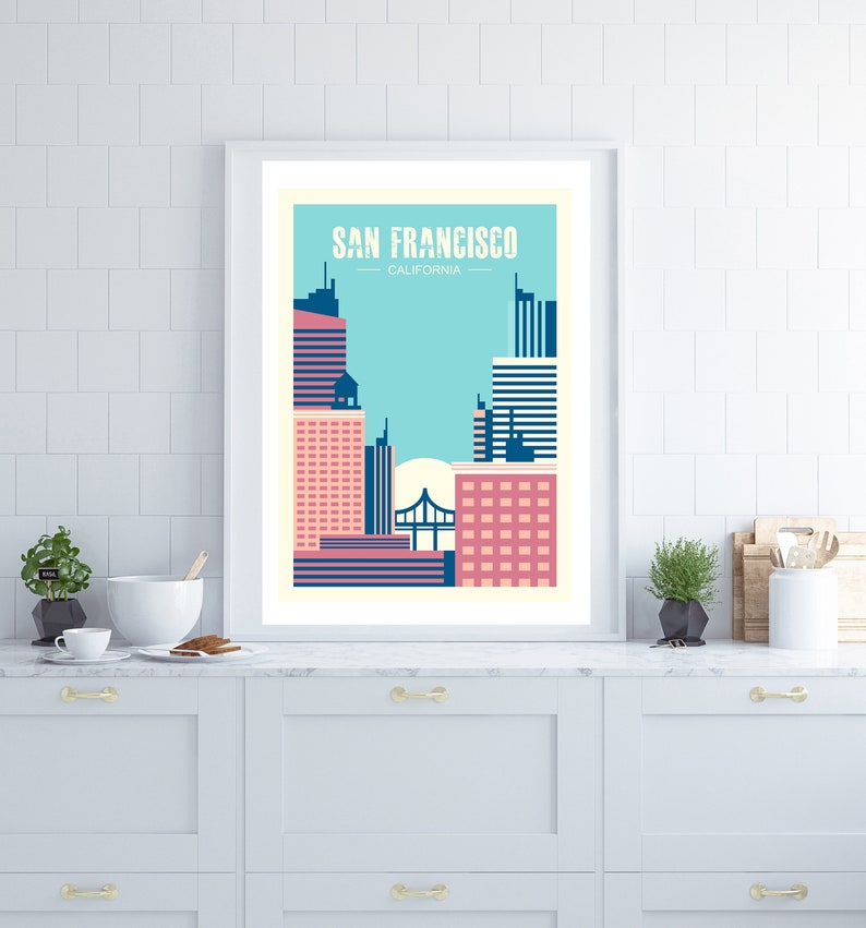 May include: A framed poster with a minimalist design depicting the San Francisco skyline in pink, blue, and white. The text "SAN FRANCISCO, CALIFORNIA" is at the top of the poster.