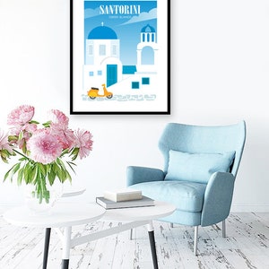 May include: A framed poster with a blue and white illustration of a building in Santorini, Greece. The poster has the text "Santorini Greek Islands" at the top. A yellow scooter is parked in front of the building.