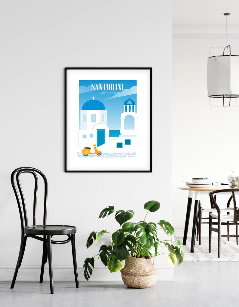 May include: A black framed print with a colorful illustration of a white building with a blue dome, a yellow scooter, and the text "Santorini Greek Islands".