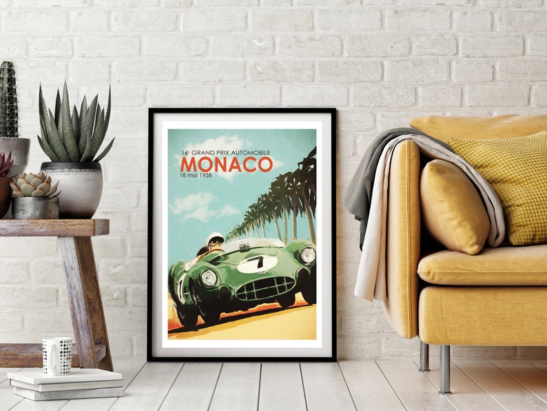 May include: A vintage poster for the 14th Grand Prix Automobile Monaco, held on May 15, 1958. The poster features a green race car driving on a road with palm trees in the background.