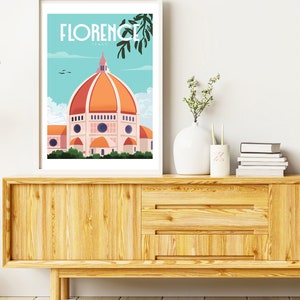 Może przedstawiać: Biały plakat w ramie z niebieską i pomarańczową ilustracją Duomo we Florencji we Włoszech. Plakat zawiera tekst "FLORENCE ITALY" u g&oacute;ry.