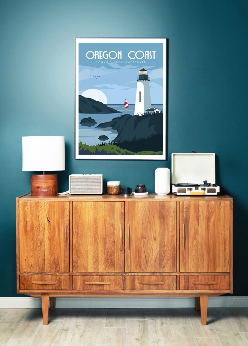 May include: A vintage-style wooden cabinet with four doors and three drawers. The cabinet is decorated with a framed poster that reads "Oregon Coast Yaquina Head Lighthouse". The poster features a lighthouse on a rocky coastline with a sailboat in the distance.
