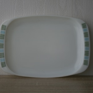 May include: White rectangular serving tray with a blue and green geometric pattern around the edge.