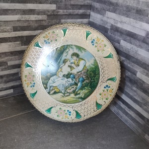 Vintage Tin featuring a regency couple