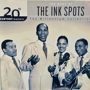 May include: A CD case for The Best of The Ink Spots, The Millennium Collection. The cover features a black and white photograph of four men in suits, with one holding a guitar. The text reads 20th Century Masters and The Ink Spots.