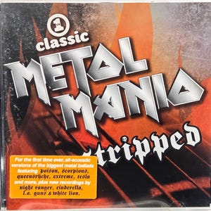 May include: A CD case with the title "METAL MANIA Stripped" in a bold, metallic font. The cover features a fiery orange and red background. A sticker lists the artists featured on the album.