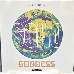 May include: A compact disc jewel case featuring a white cover with a central circular graphic of the Earth in shades of blue, green, and yellow. The text SOHO appears at the top and center, while the word GODDESS is printed in a stylized font below.