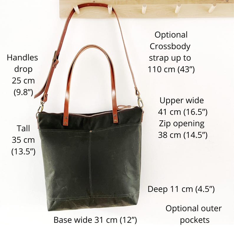 The bag hangs on a rack and theres text explaining the measurements. It also says that you can add a crossbody strap and outer pockets.