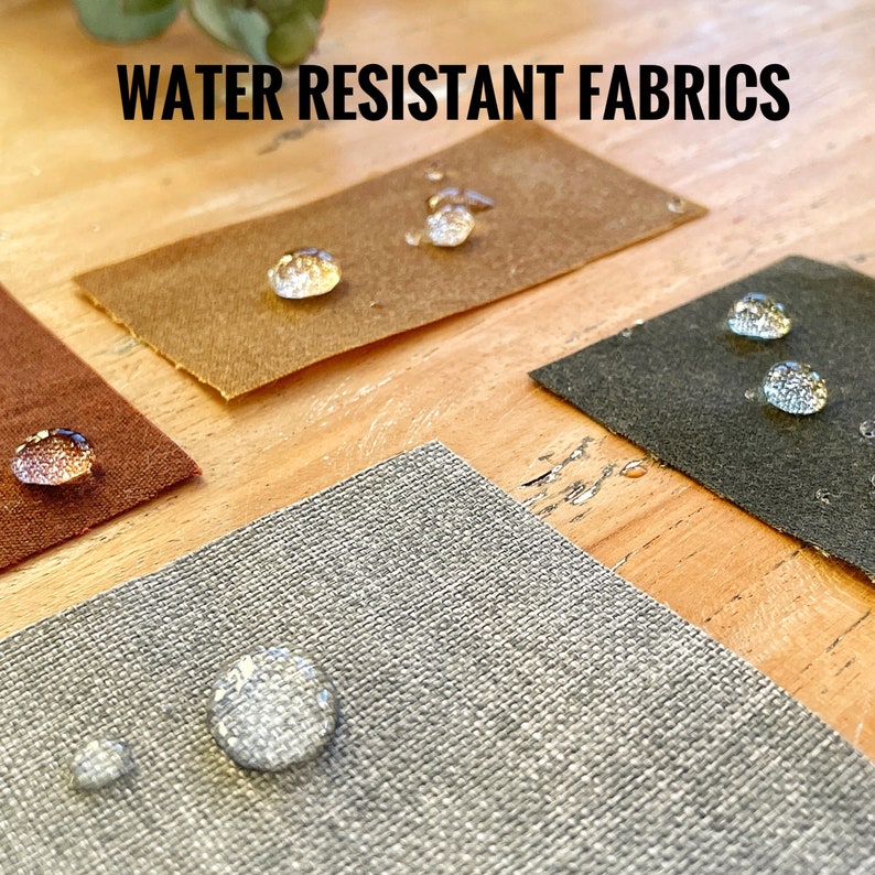Swatches of waxed canvas and the grey lining fabric. There are drops of water on the swatches to illustrate the waterproof condition of the fabrics.