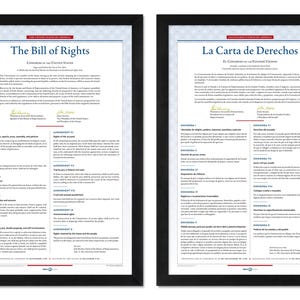 May include: Two framed prints of the Bill of Rights, one in English and the other in Spanish. The documents feature black frames and white paper with text. The English version is titled "The Bill of Rights" and the Spanish version is titled "La Carta de Derechos".