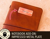 Notebook add on: impressed metal plate