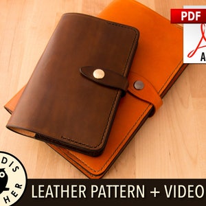 Puede incluir: Dos cuadernos de cuero, uno marrón y otro naranja, apilados uno encima del otro. Los cuadernos están cerrados y tienen un diseño sencillo. El texto "LEATHER PATTERN + VIDEO #3" está impreso debajo de los cuadernos.