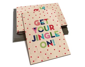 May include: A stack of Christmas cards with a red polka dot pattern and the text "GET YOUR JINGLE ON!" in colorful letters.