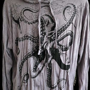 May include: Gray long-sleeved hoodie featuring a large black octopus graphic on the front. The hoodie has a drawstring hood and a relaxed fit. The octopus design includes detailed tentacles and suction cups, creating a striking visual.