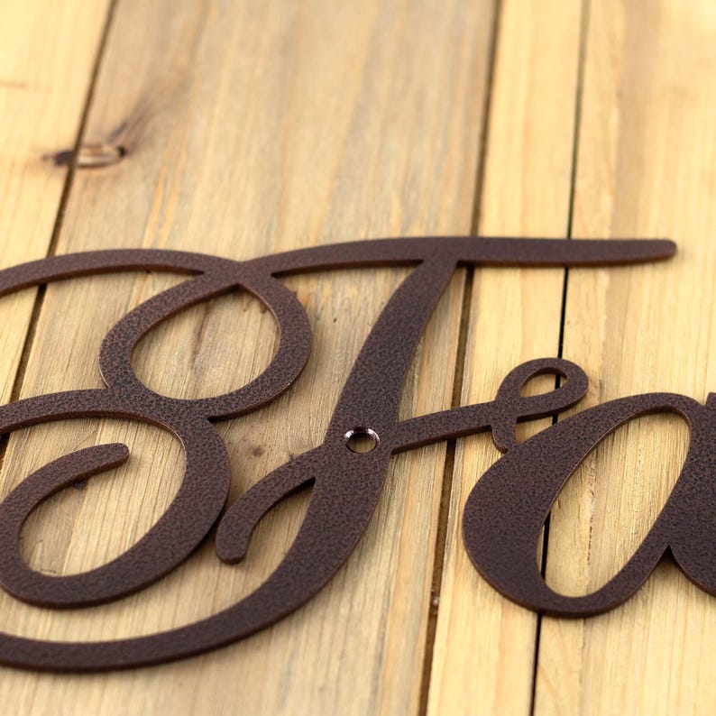 Close up of copper vein powder coat on our Faith metal wall decor.