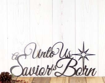 May include: Black metal Christmas sign with the words "Unto Us a Savior is Born" and a star with eight points.